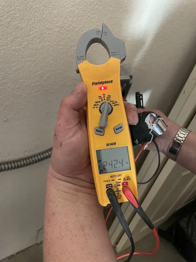 Voltage testing with clamp meter during Outlet Installation in North Oaks